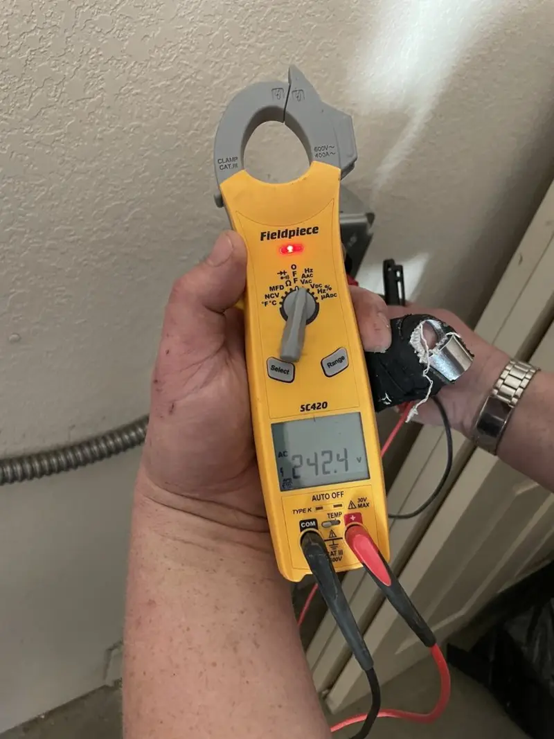 Voltage testing with clamp meter during Outlet Installation in Kane